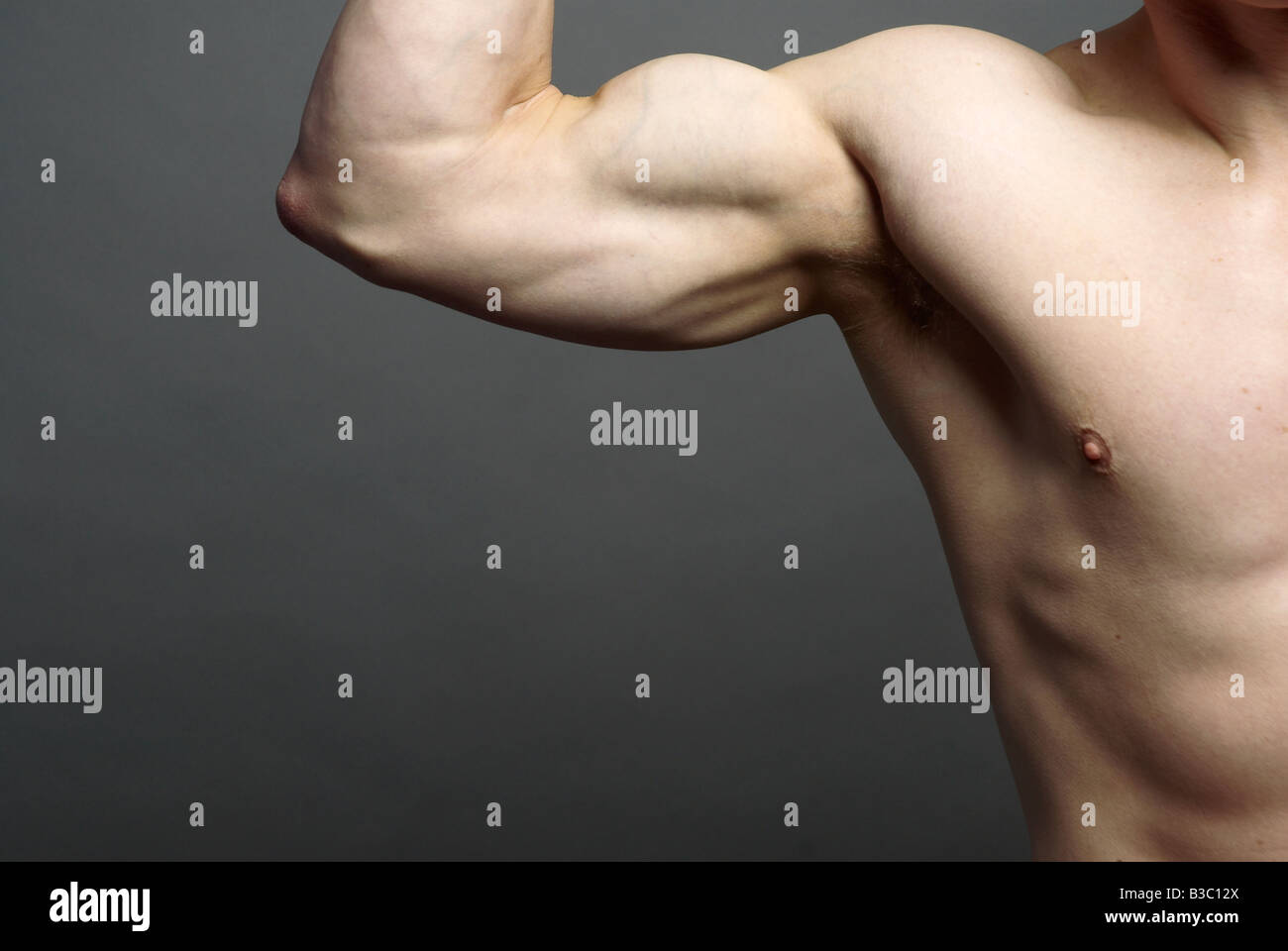 A man tensing his bicep muscle Stock Photo