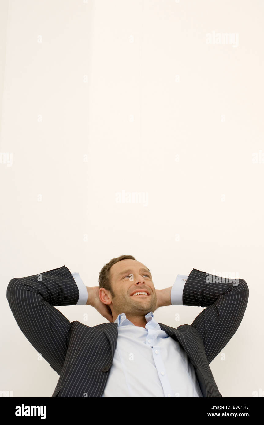 Portrait of a self assured businessman reclining Stock Photo Alamy
