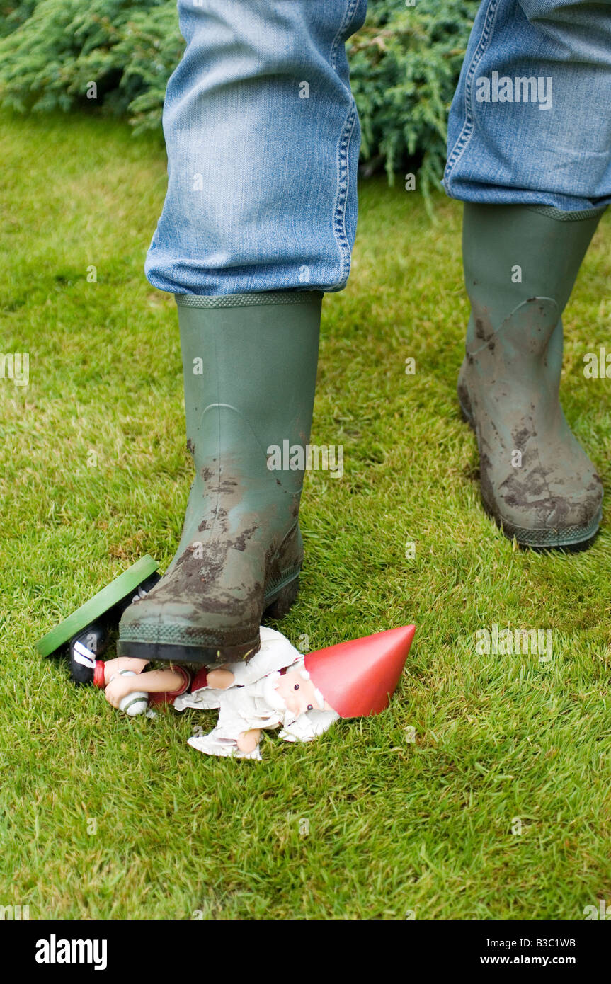 A foot trampling on a garden gnome Stock Photo - Alamy