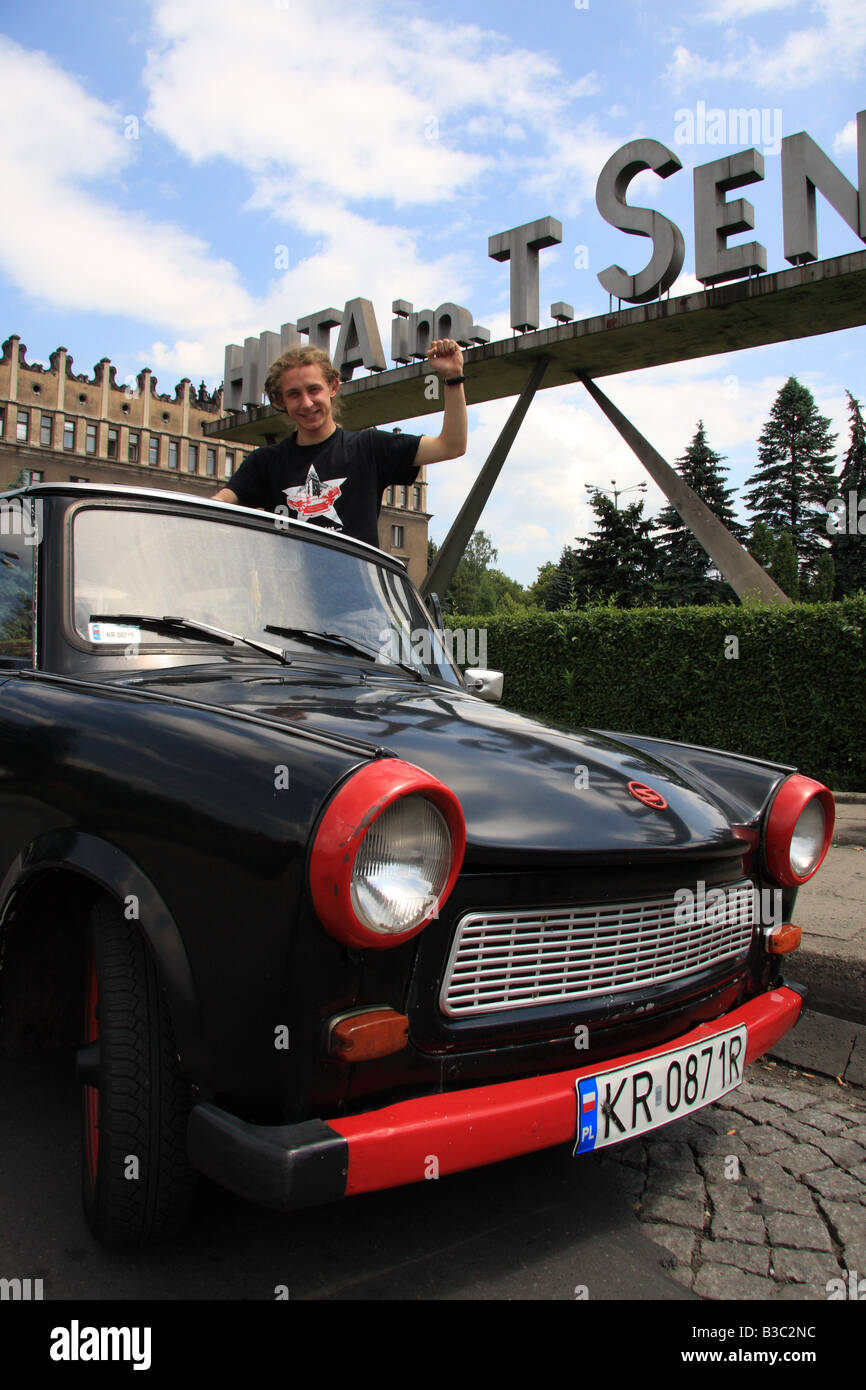 Tour guide, Eryk Grasela pauses  'Crazy Guides' Trabant car by Huta im Sendzimira steelworks, Nowa Huta, near Krakow, Poland Stock Photo