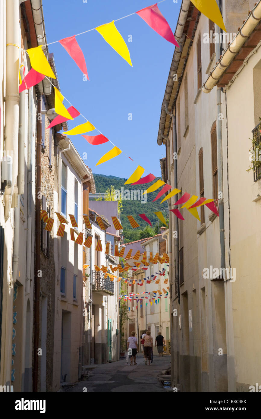 A street is decorated with flags and streamers in both Catalonian and French colours for the French national holiday Stock Photo