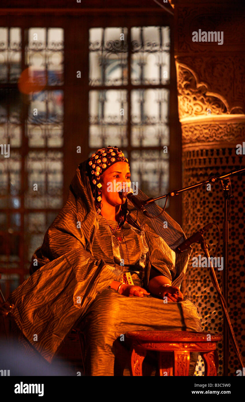 Morocco, Fes. One of the women in The Tartit Women's Ensemble from Mali performs in the Dar Tazi during the Fes Festival of World Sacred Music. Stock Photo