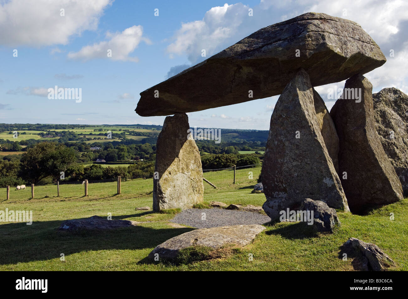 UK, Wales, Pembrokeshire. A young boy visits the site of the ancient neolithic dolmen at Pentre Ifan Stock Photo