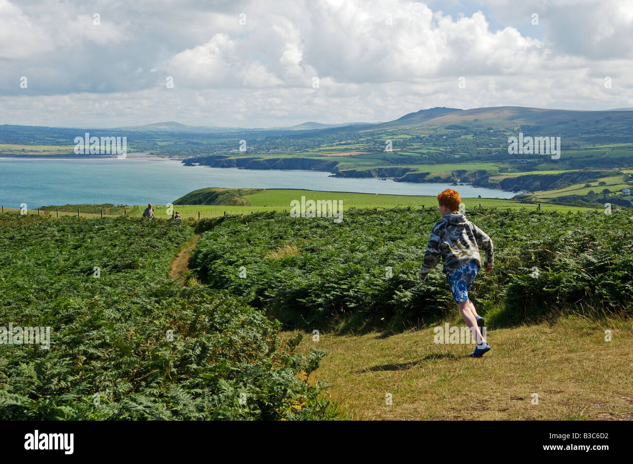 UK Wales Pembrokeshire A Boy Runs Along The Pembrokeshire Coastal