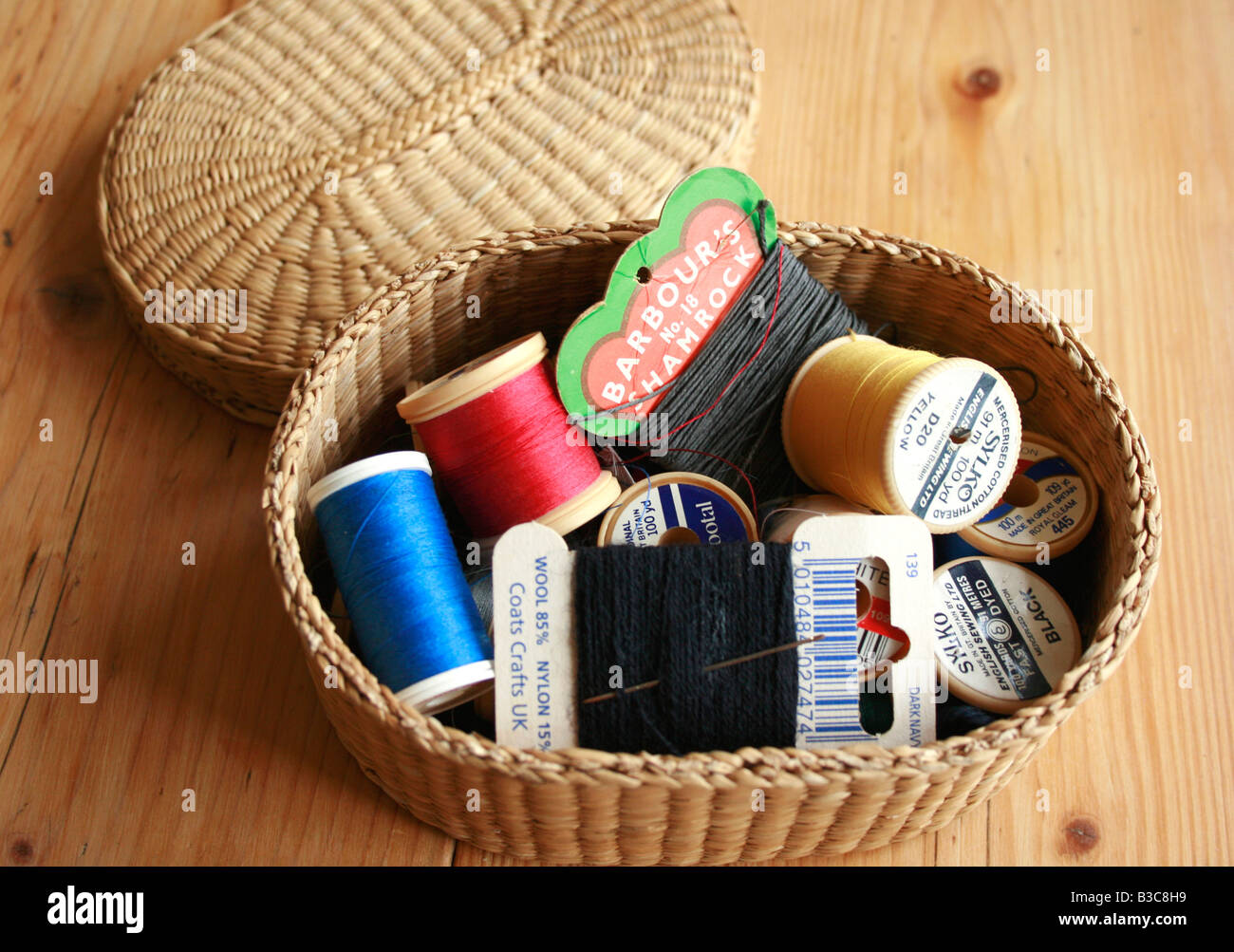 Cotton Reels / Bobbins and Threads in a small basket Stock Photo