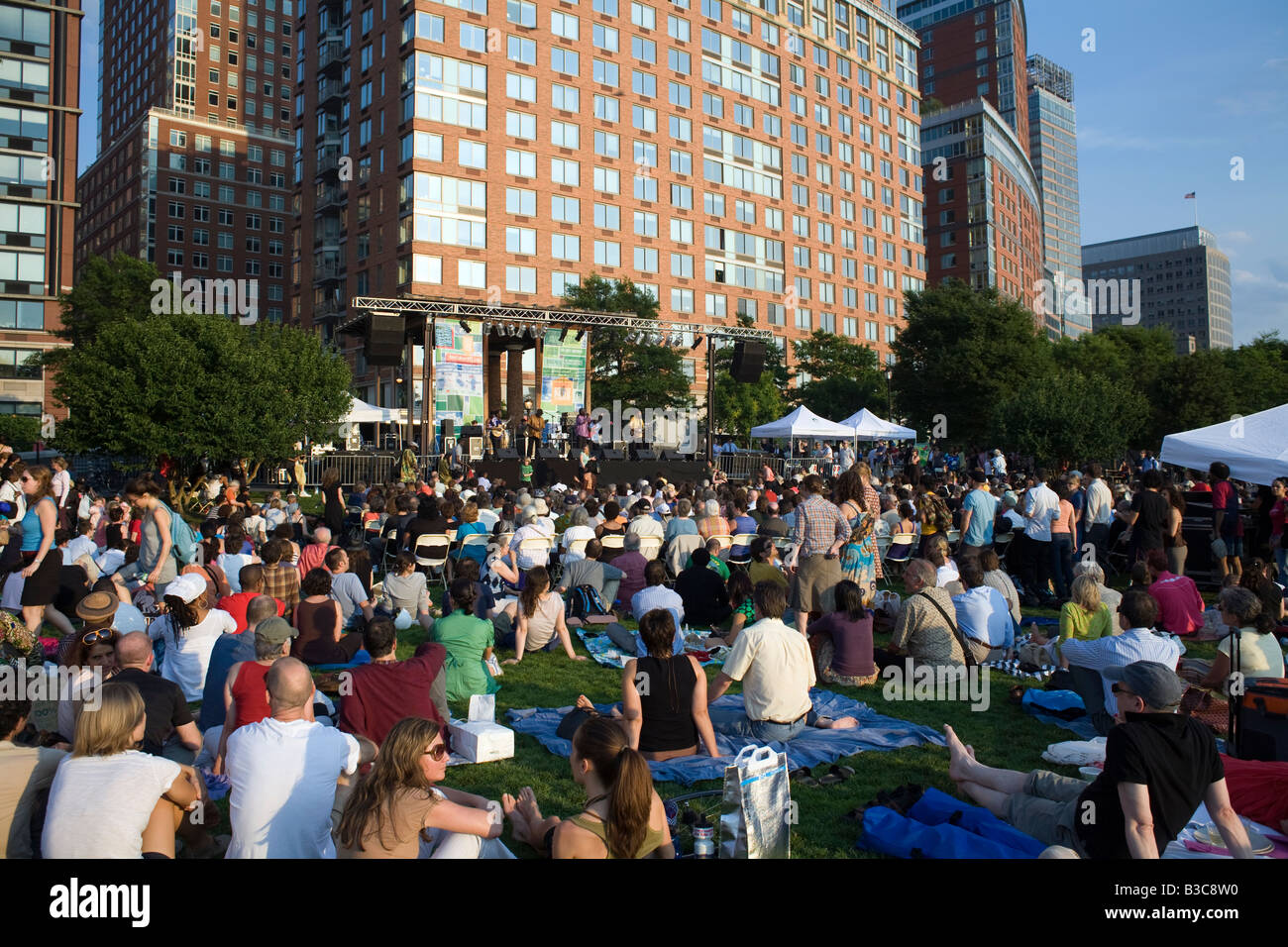 Audience on the lawn at Rockefeller Park in New York City watching an