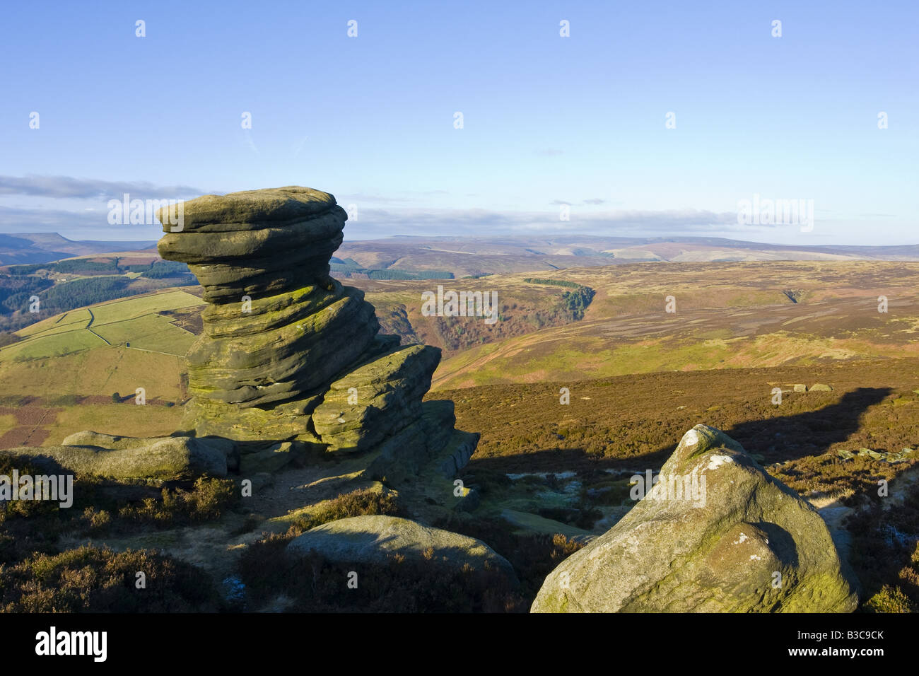 View of the Salt Cellar stone near Derwent Edge with the hills behind. Lit by the early morning light. Stock Photo