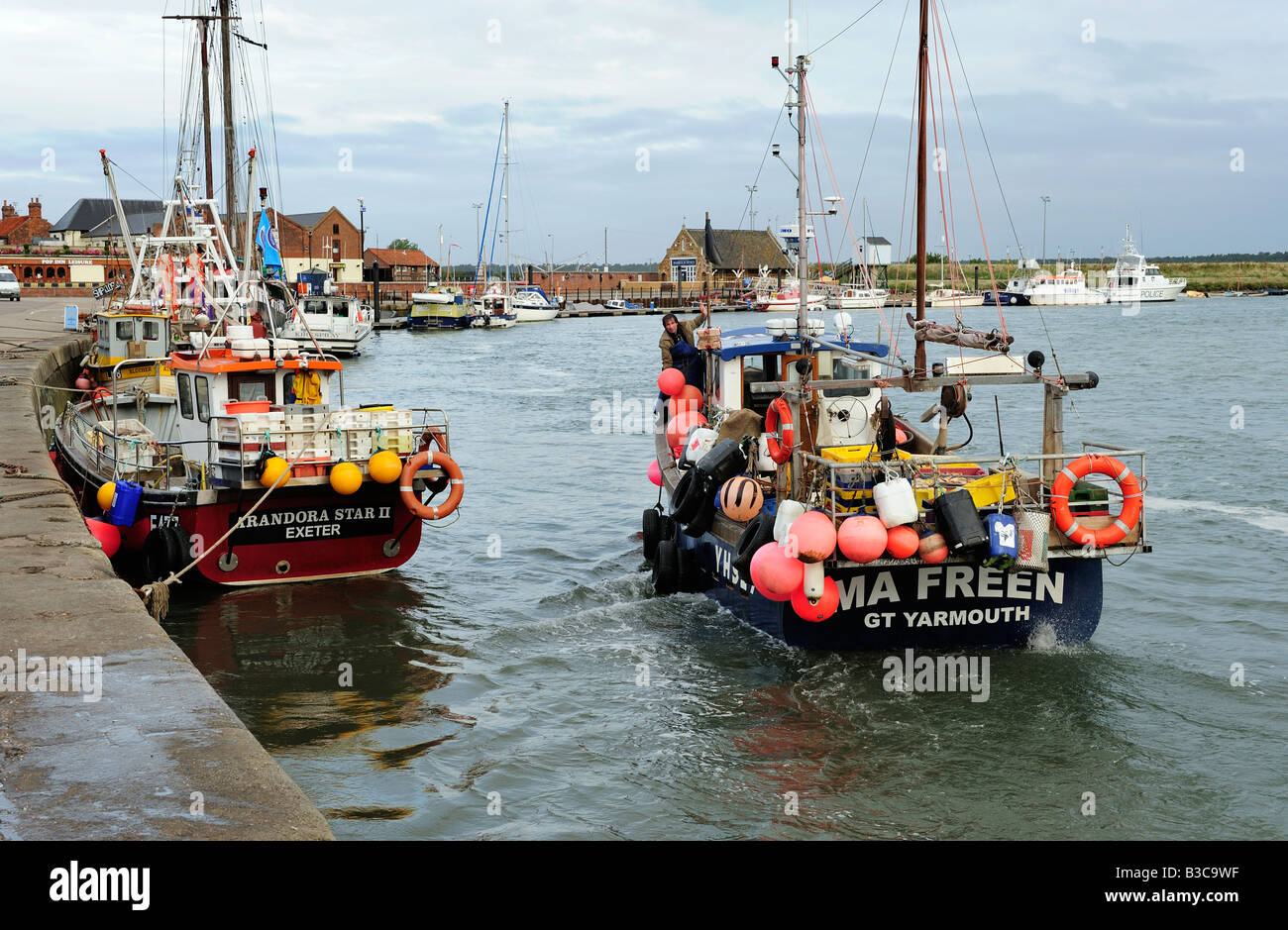 Fishing boat leaving the harbour at Wells-Next-the-Sea, Norfolk Stock Photo