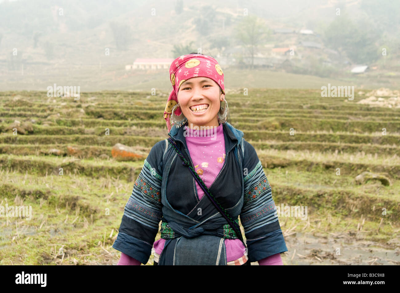 a happy smiling Hmong girl in the mountains surrounding Sapa Vietnam Stock Photo