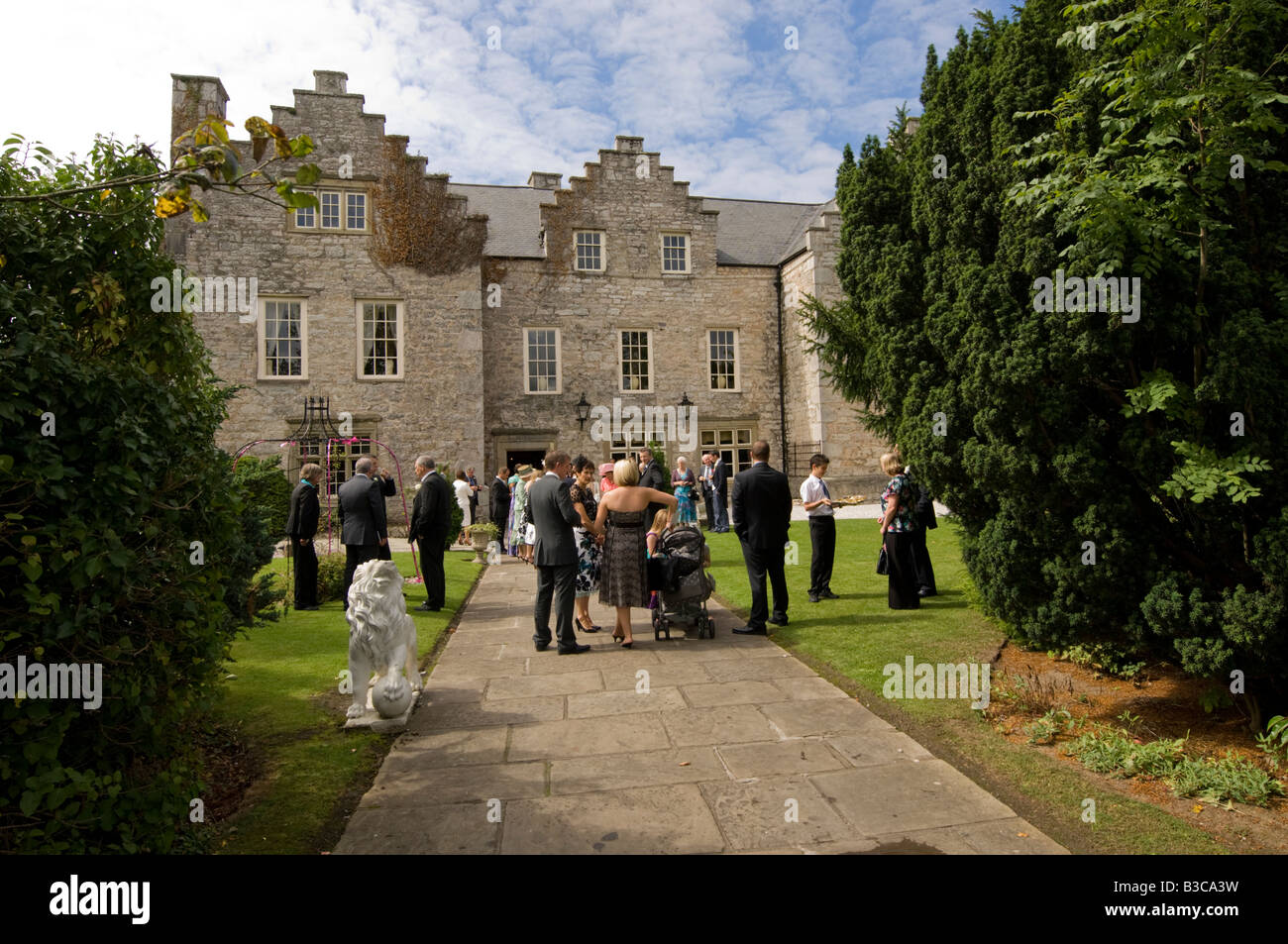 wedding guests at Y Faenol Fawr country house hotel Bodelwyddan North Wales UK, summer afternoon, Tudor era building Stock Photo