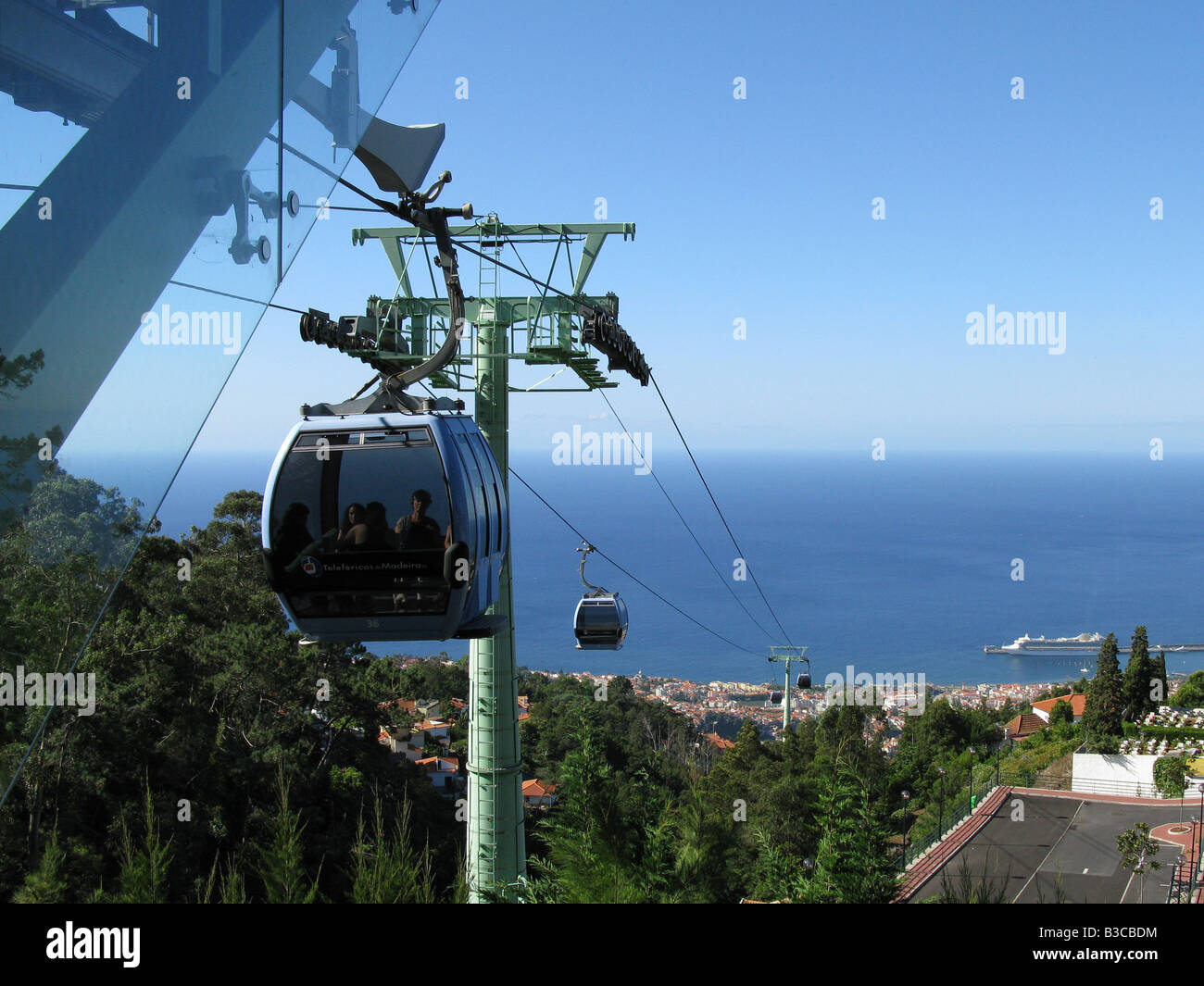 Cable car that connects Funchal to Monte on the Portuguese island of Madeira. P&O ship Ventura in the distance. Funchal, Madeira, Portugal, Europe Stock Photo