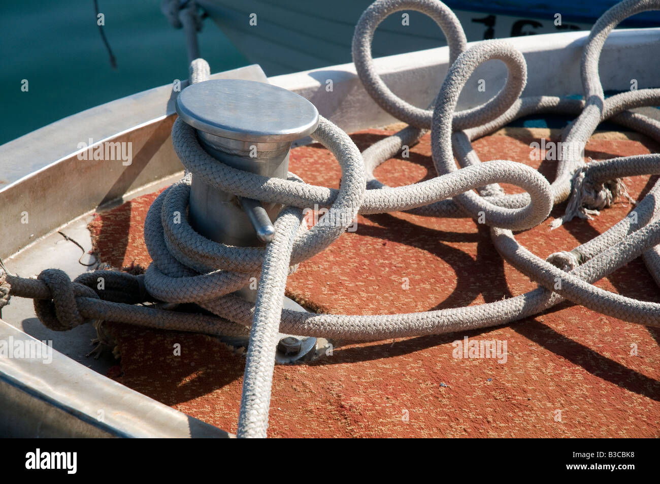 a bollard with a rope on an old wooden boat Stock Photo