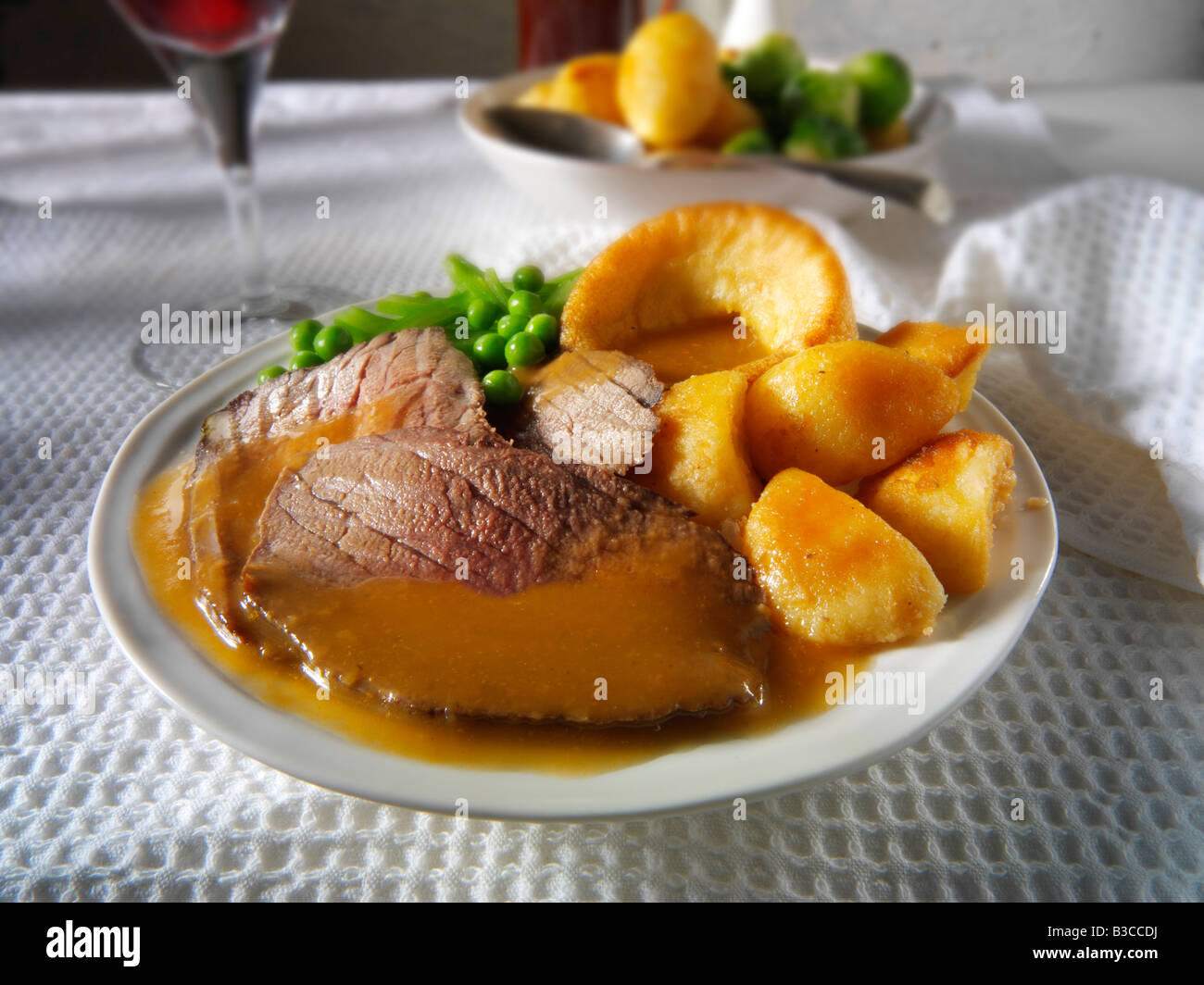 Traditional British roast dinner with roast beef, roast potatoes, yorkshire puddings. 21 days hung Stock Photo