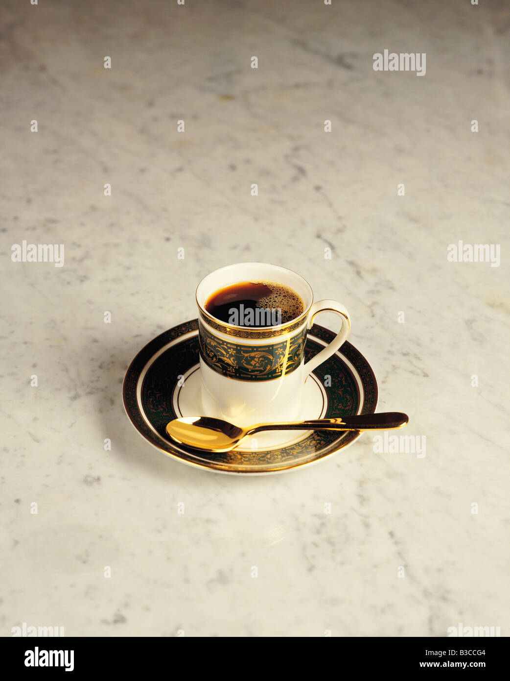 Still life of cup of black Espresso coffee on marble cafe table. Stock Photo