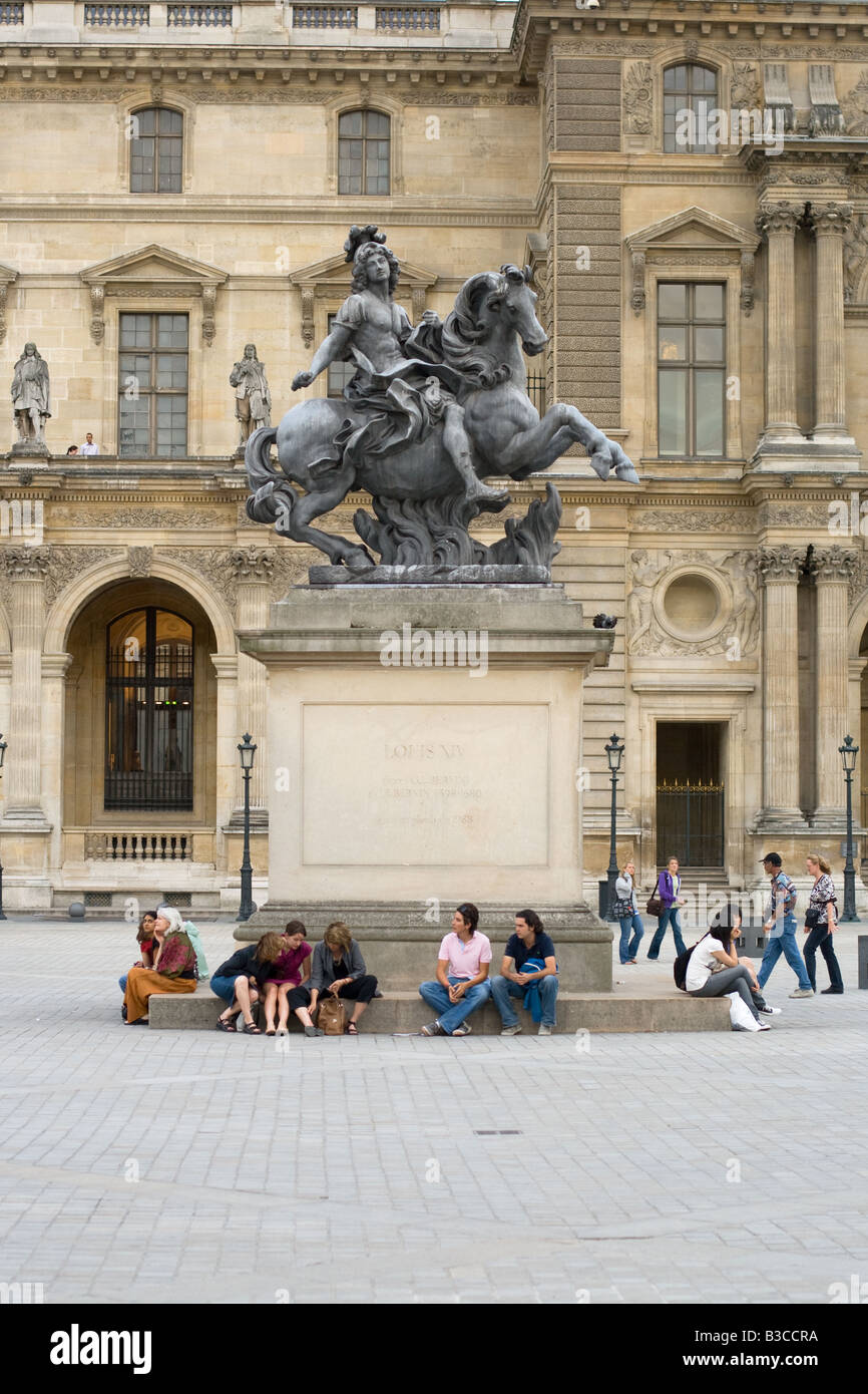 Statue of Louis XIV near the Louvre Pyramid in Paris, France Stock
