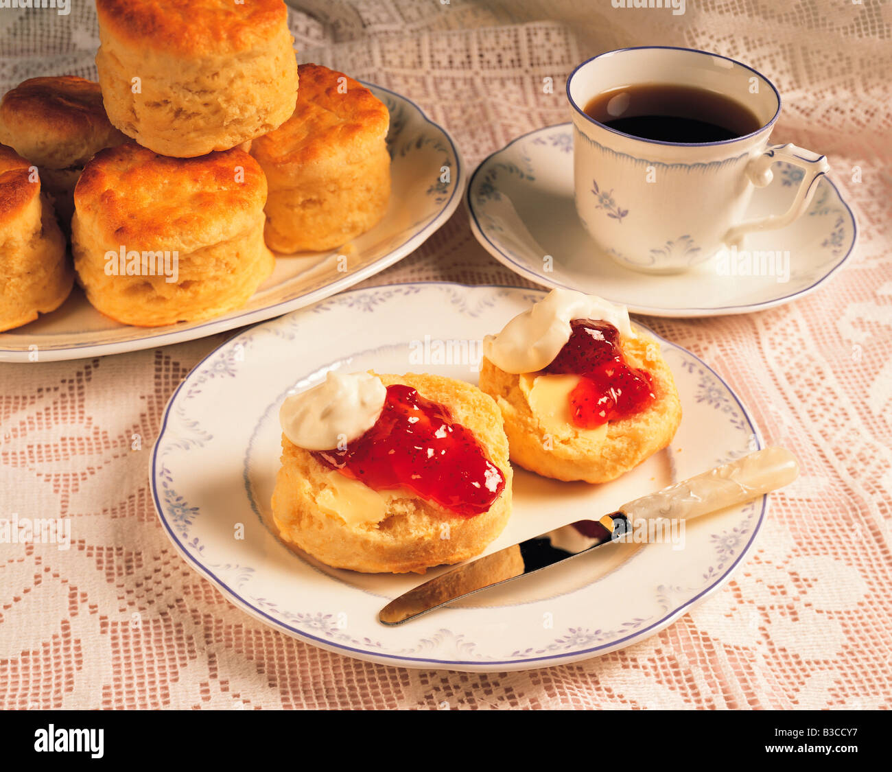 Cup of coffee with scones, cream and jam Stock Photo Alamy
