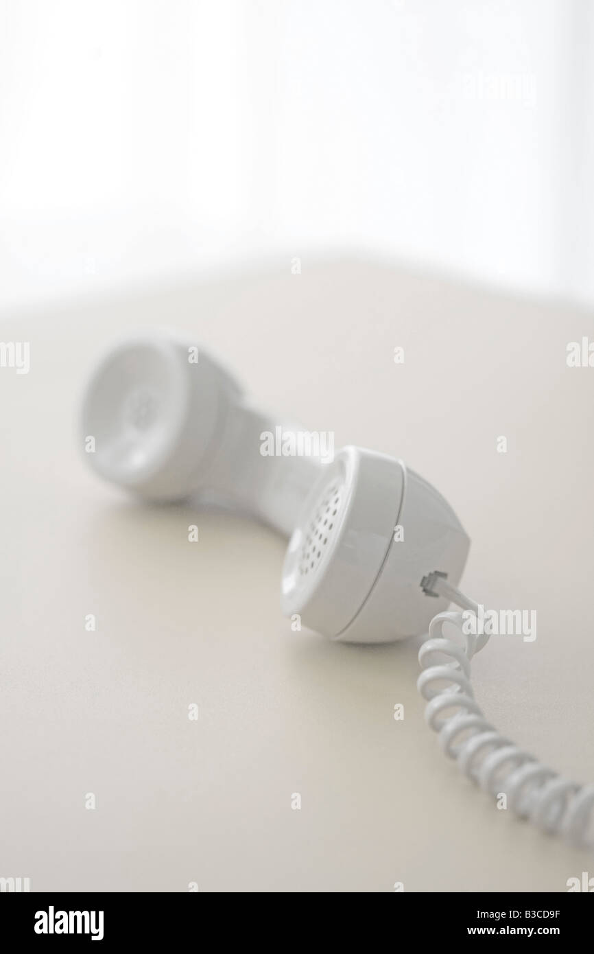 telephone receiver off the hook on table Stock Photo Alamy