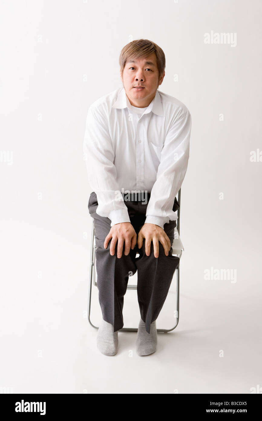 Mid adult man sitting Stock Photo