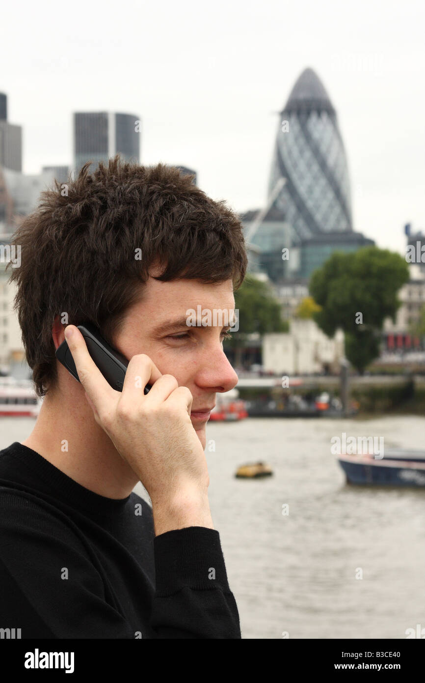 A young man using a mobile phone in London, England, U.K Stock Photo