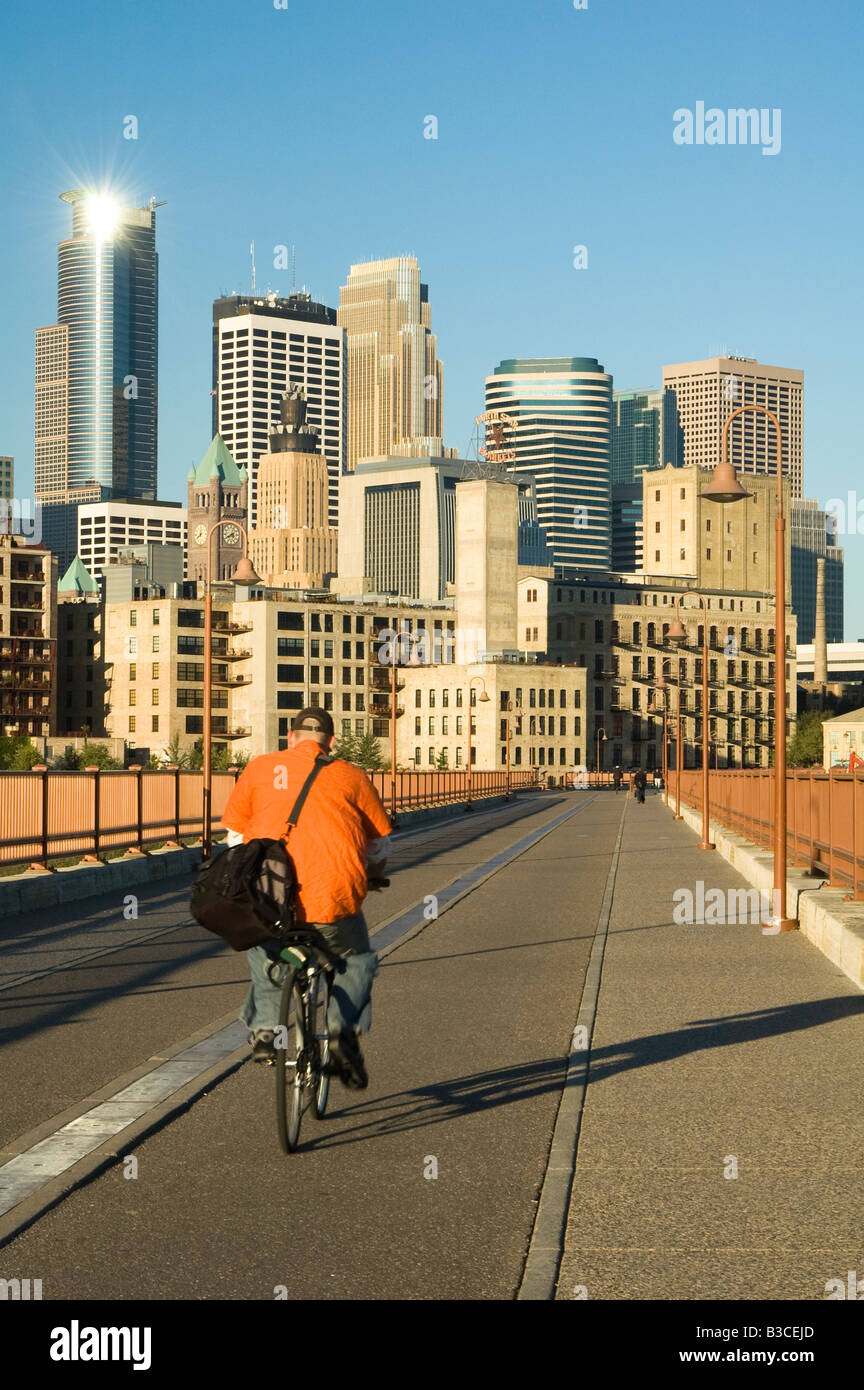 biker going to work on a walkway across the Minnesota River with the Minneapolis skyline in the background Stock Photo