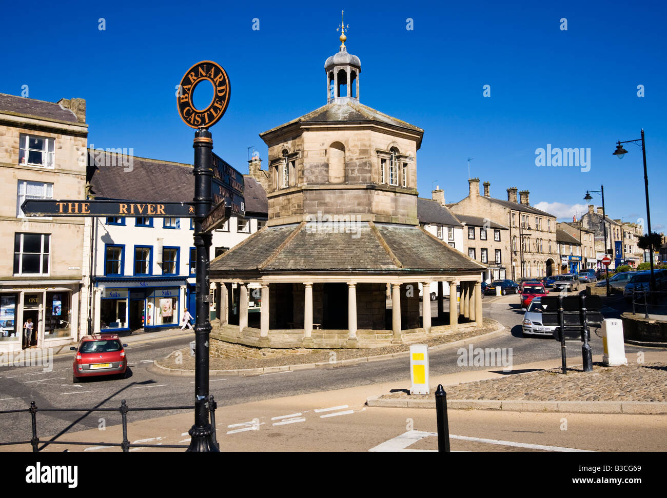 Old Market Cross and town directions signpost in Barnard Castle, County Durham, England UK Stock Photo