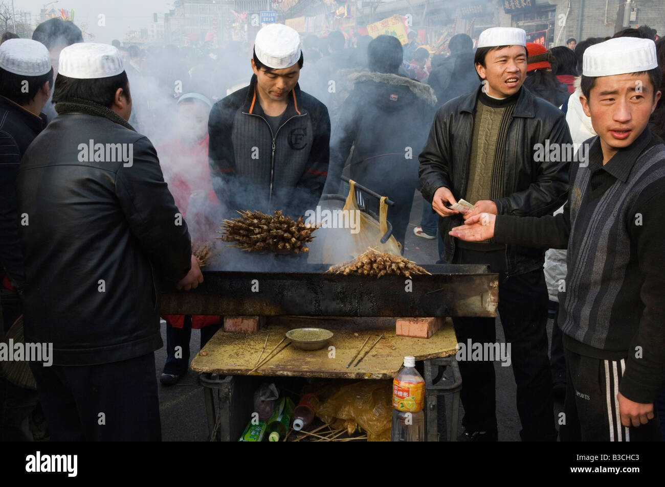 China, Beijing. Chinese New Year Spring Festival - Changdian street fair - Muslim stall vendors preparing food from Xingjiang in western China. Stock Photo