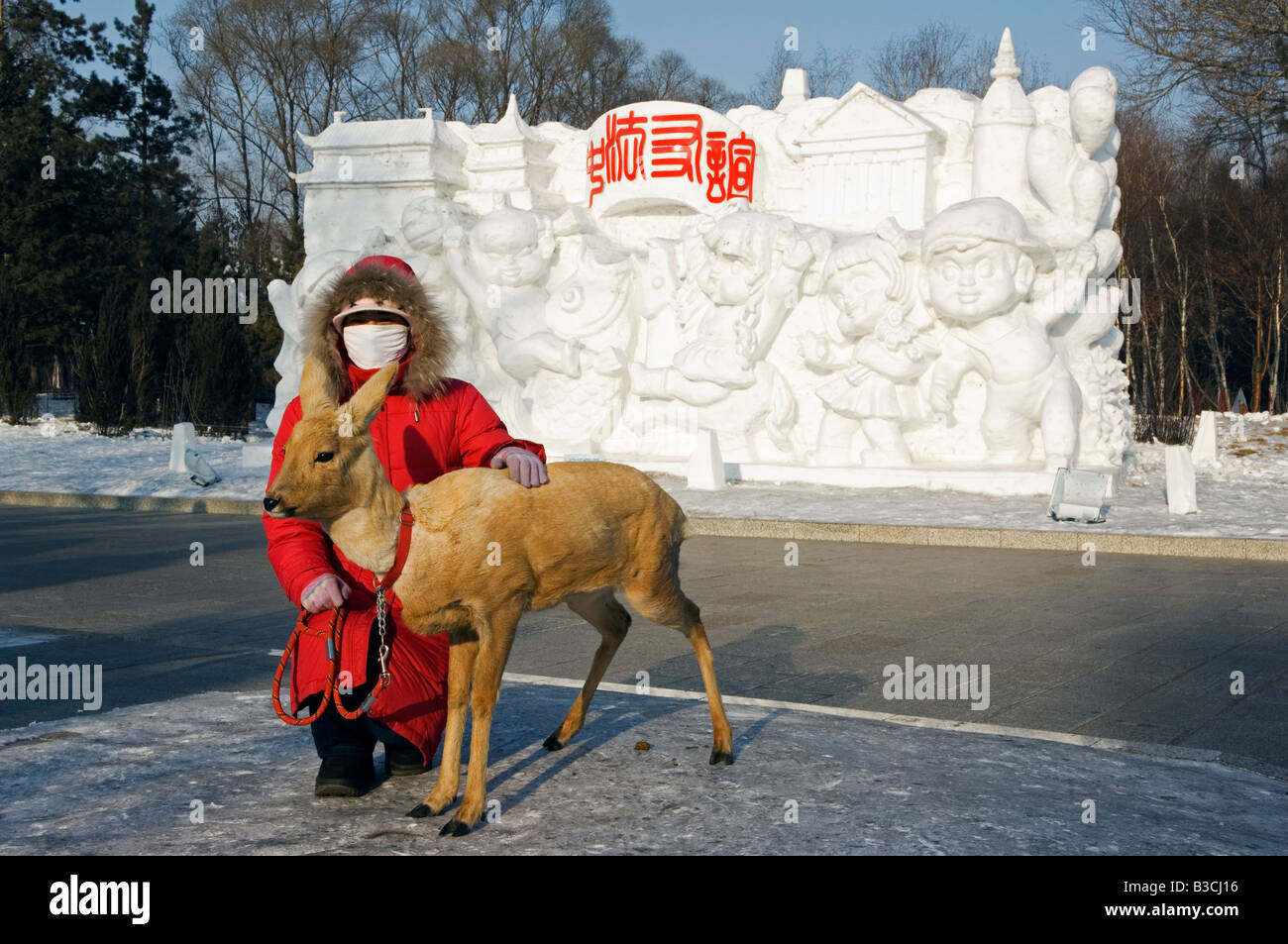 China, Northeast China, Heilongjiang Province, Harbin City. Snow and Ice Sculpture Festival at Sun Island Park. A woman with a young deer. Stock Photo