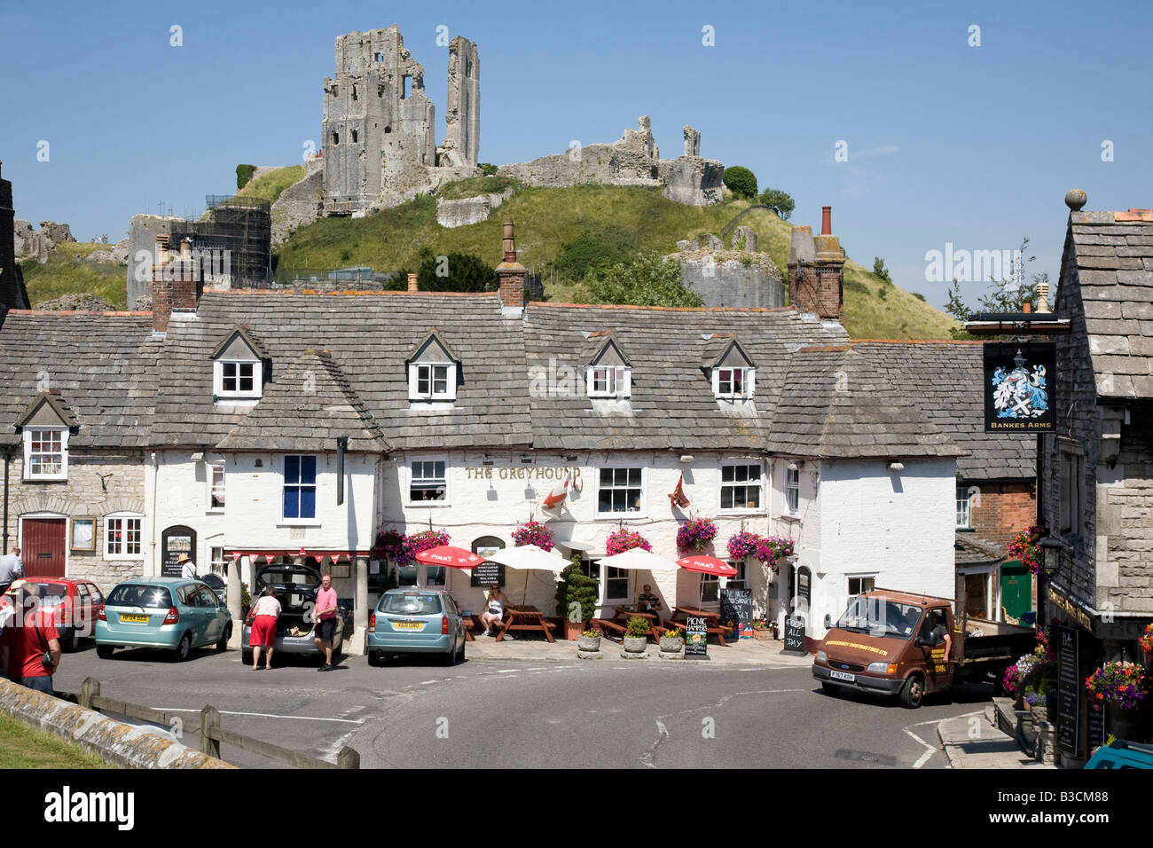 the Greyound village pub with Corfe Castle Dorset UK in background Stock Photo