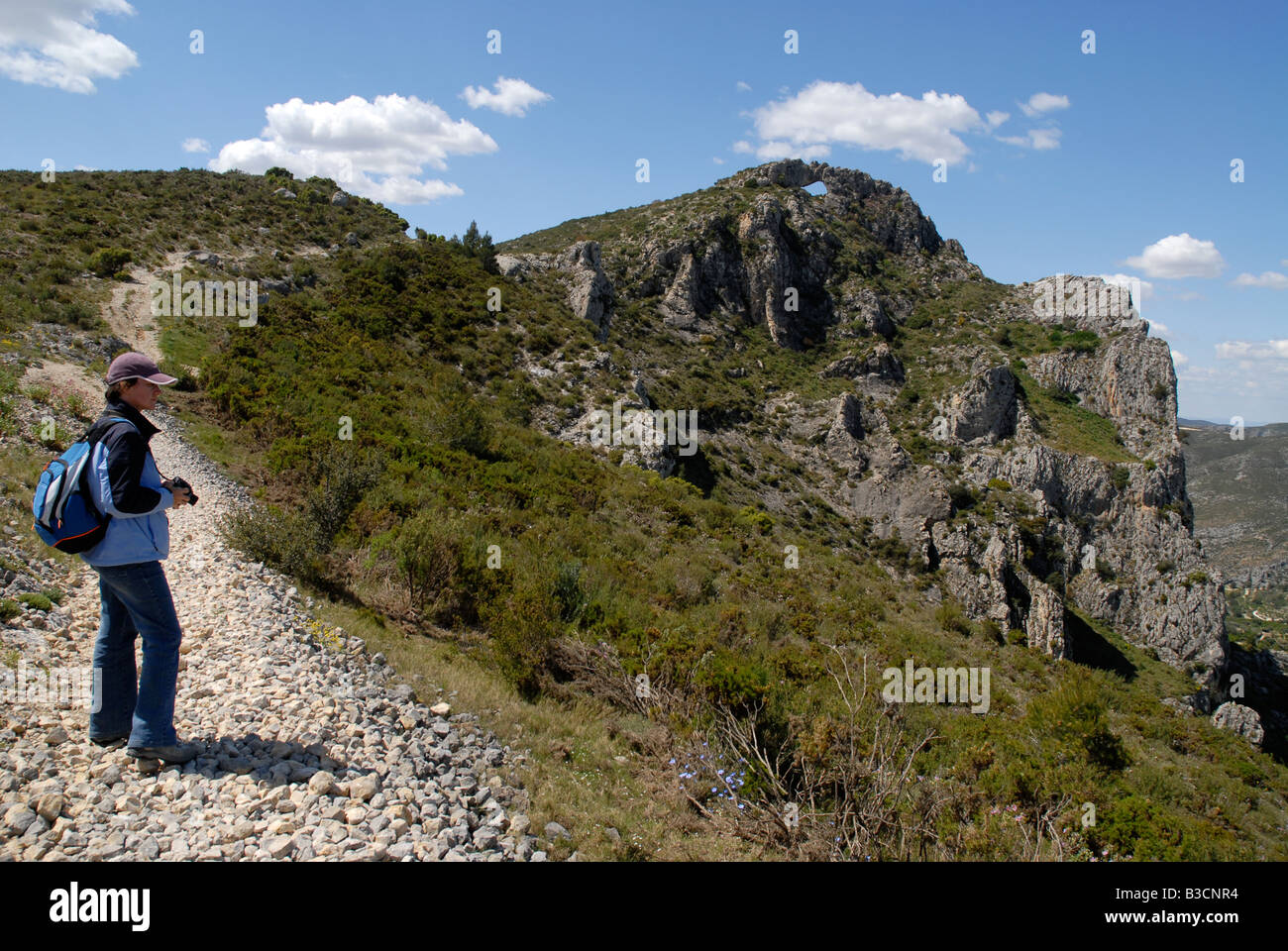 woman hiker near Penal Gros, looking to Vall de Gallinera, Sierra de la Forada, Alicante Province, Comunidad Valenciana, Spain Stock Photo