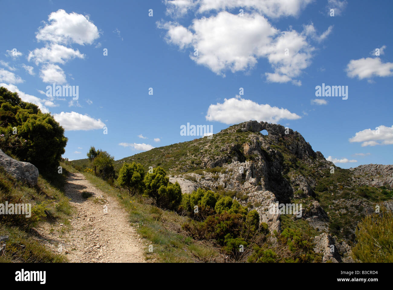 view to Penal Gros & Forada Rock Arch, Sierra de la Forada, Alicante Province, Comunidad Valenciana, Spain Stock Photo