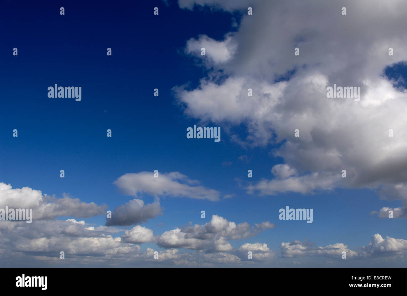 blue sky with white and grey fluffy clouds Stock Photo - Alamy