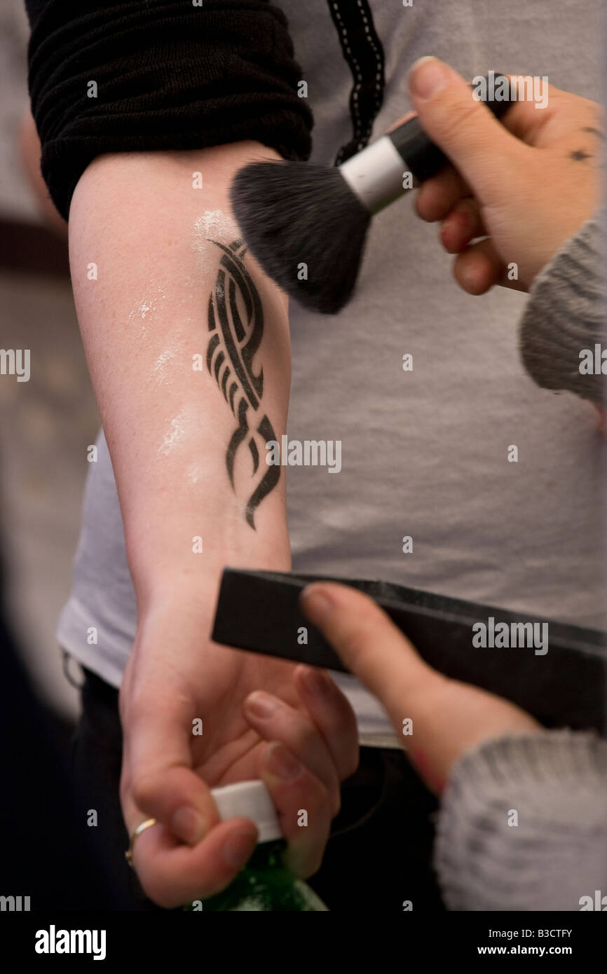 applying tattoo Stock Photo