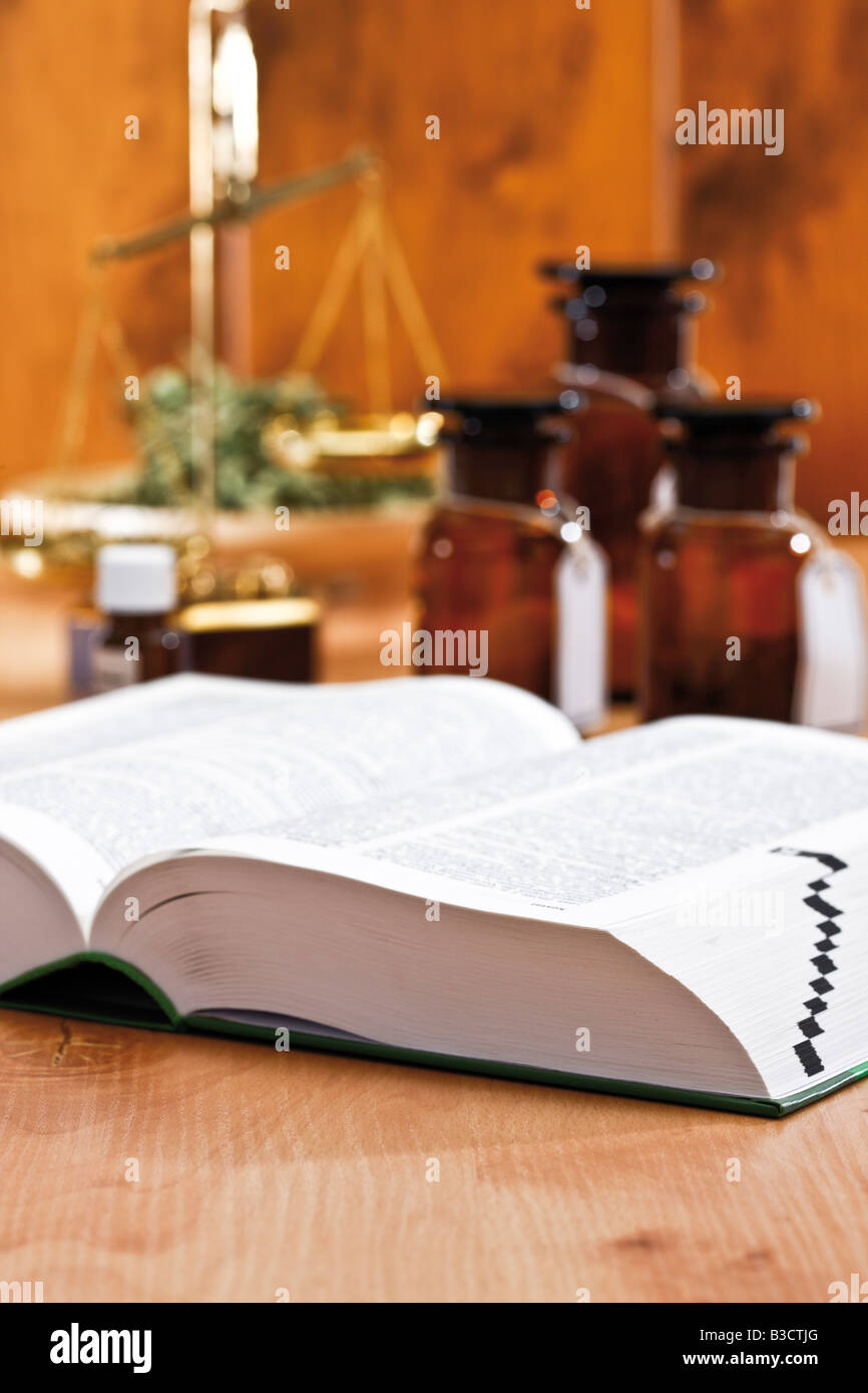 Homeopathic book, in background apothecary flasks Stock Photo
