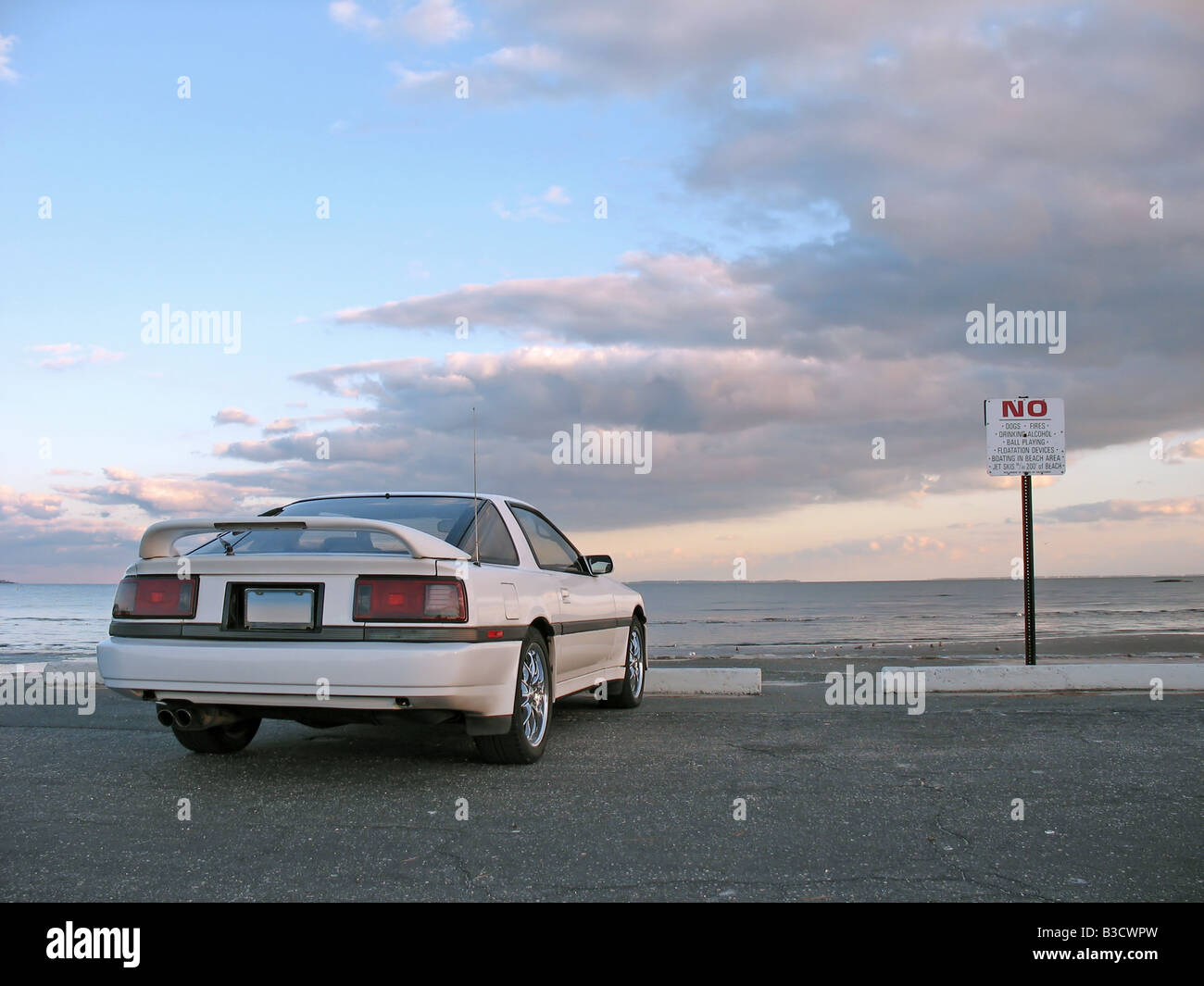 A customized white sports car parked at the beach Stock Photo