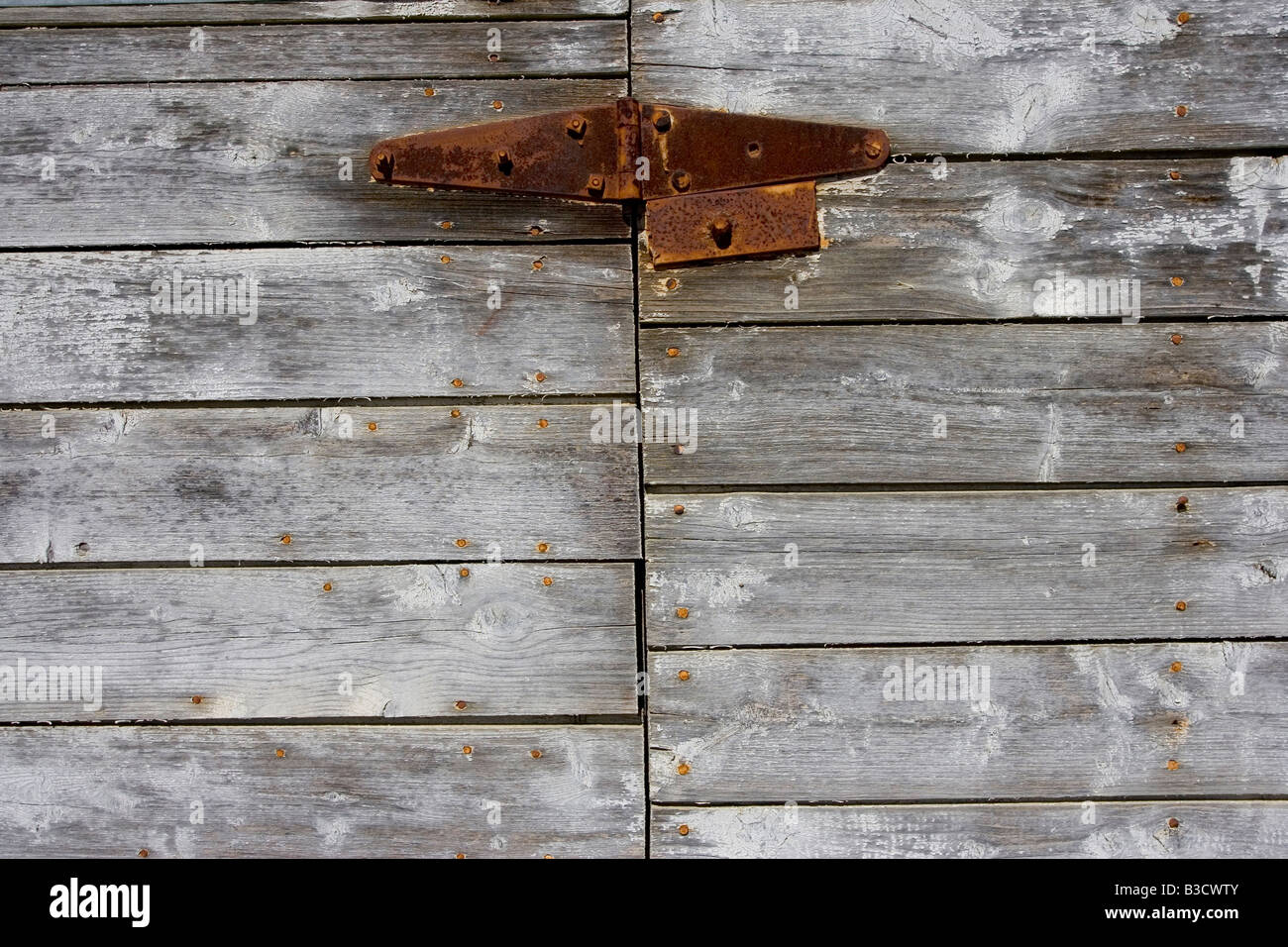 A weathered barn wood and rusty hinge Stock Photo - Alamy