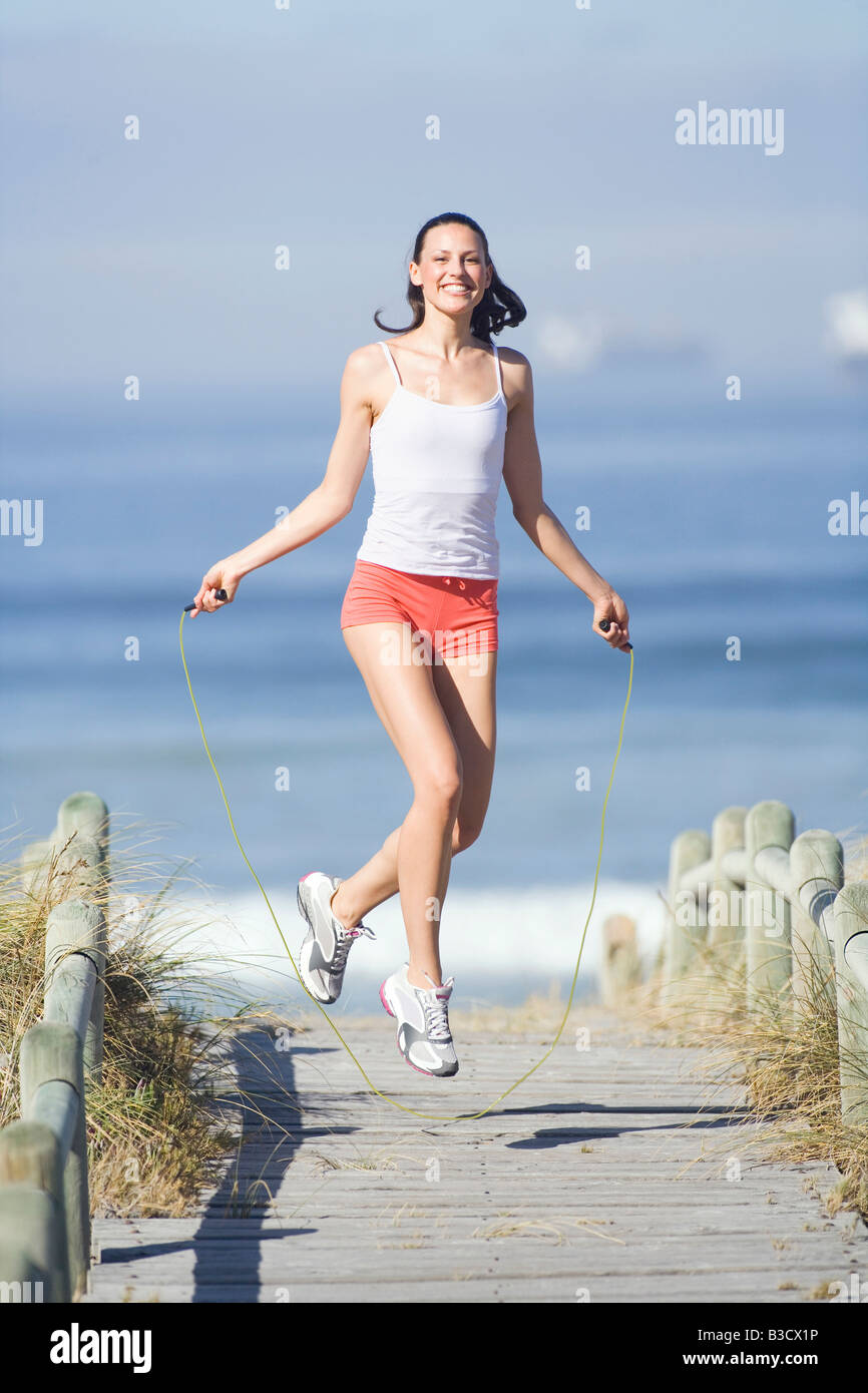Young woman using skipping rope Stock Photo - Alamy