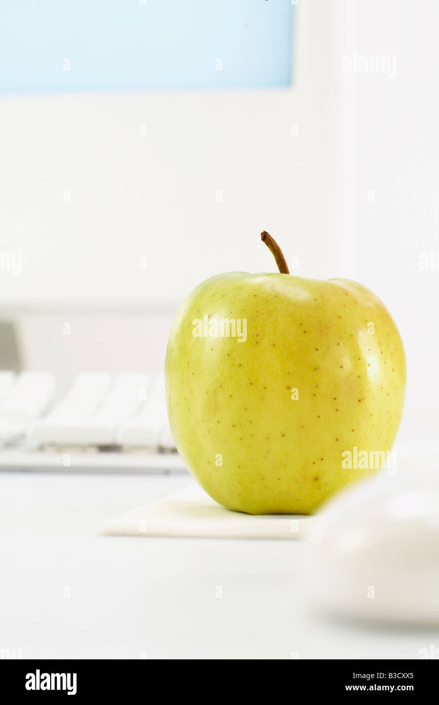Apple on office desk Stock Photo Alamy