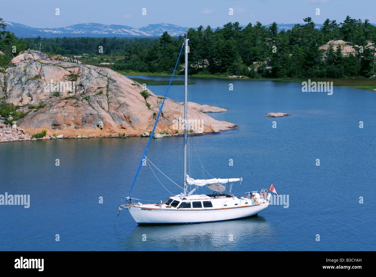 Sailboat moored on the turquoise water of Thirty Thousand Islands in Georgian Bay Ontario Stock Photo
