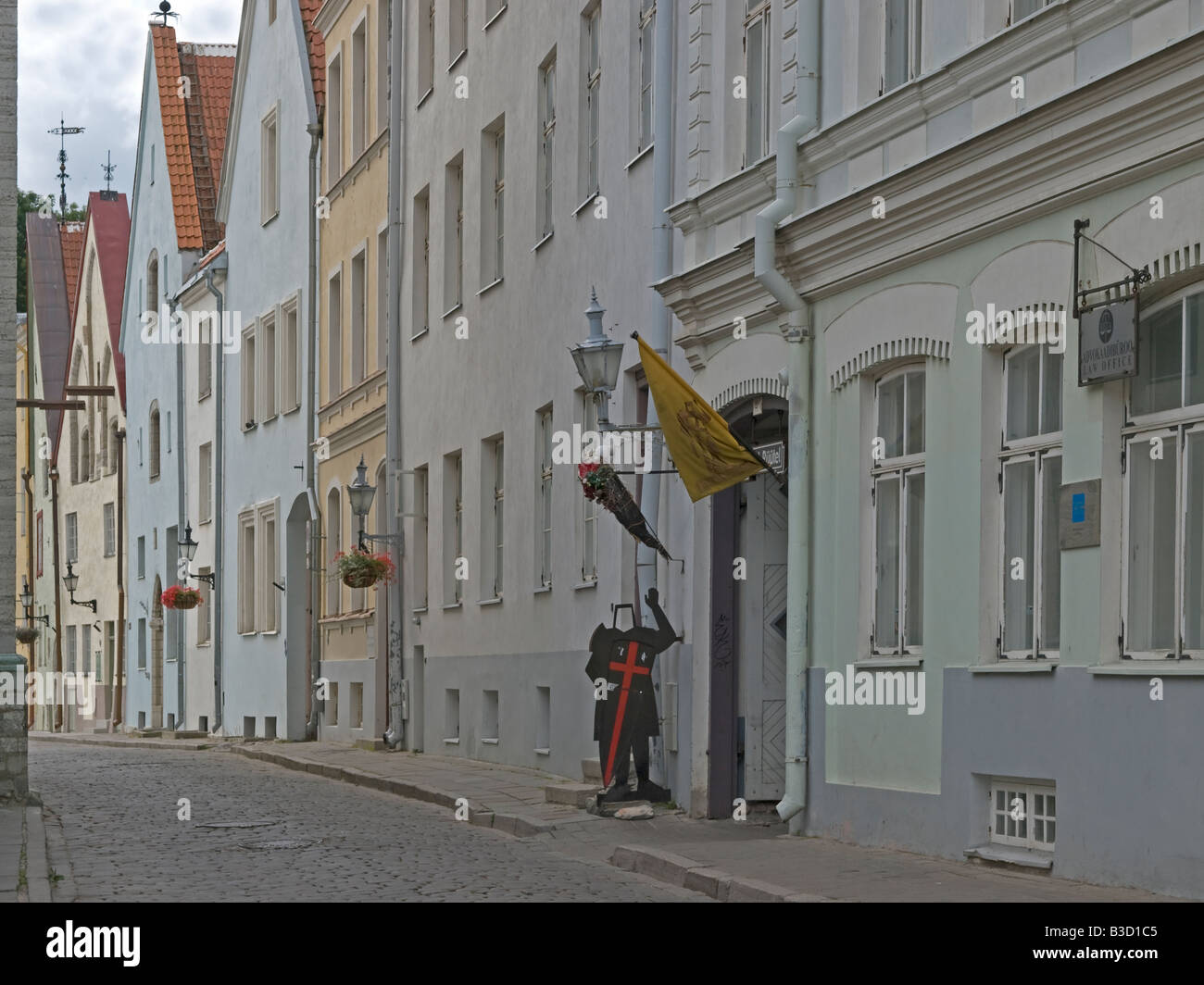 figure of a knight in front of facades of medieval houses in a street in old town in Tallinn Estonia Stock Photo