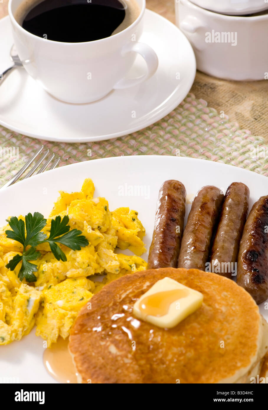 A Hearty Breakfast Plate With Pancakes Eggs And Sausages Stock Photo Alamy
