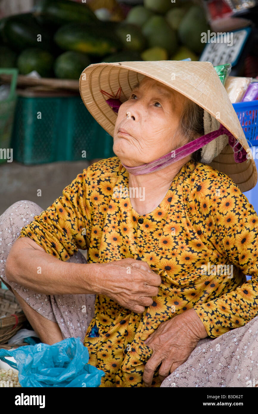 An old Vietnamese woman working at a market Stock Photo