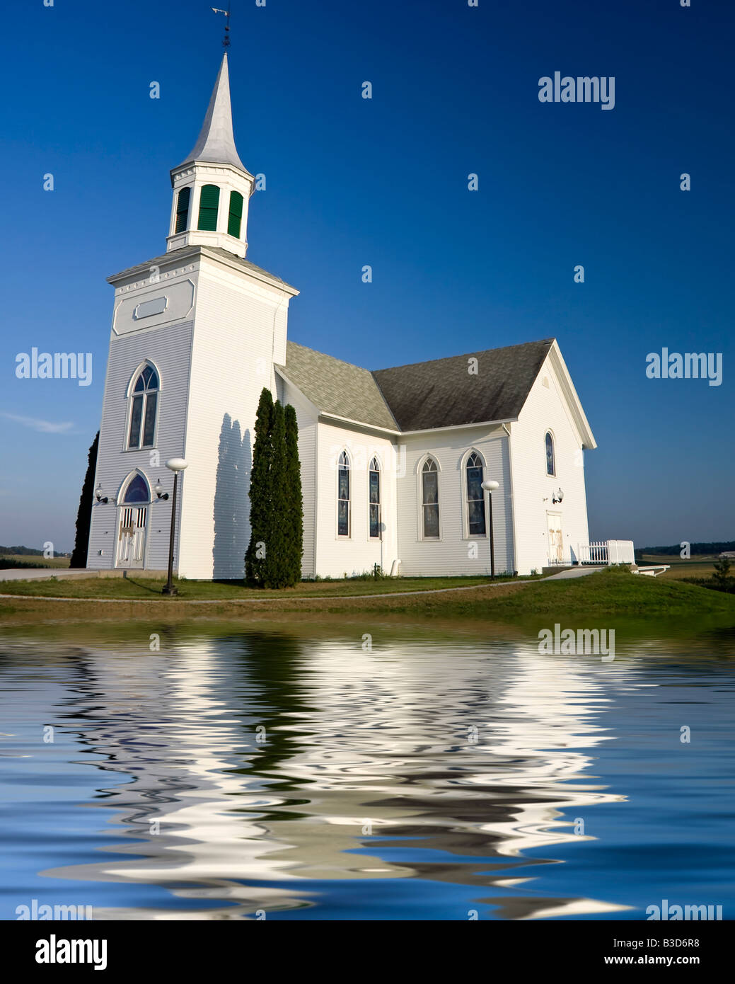 Old white church set against a dark blue sky Stock Photo - Alamy