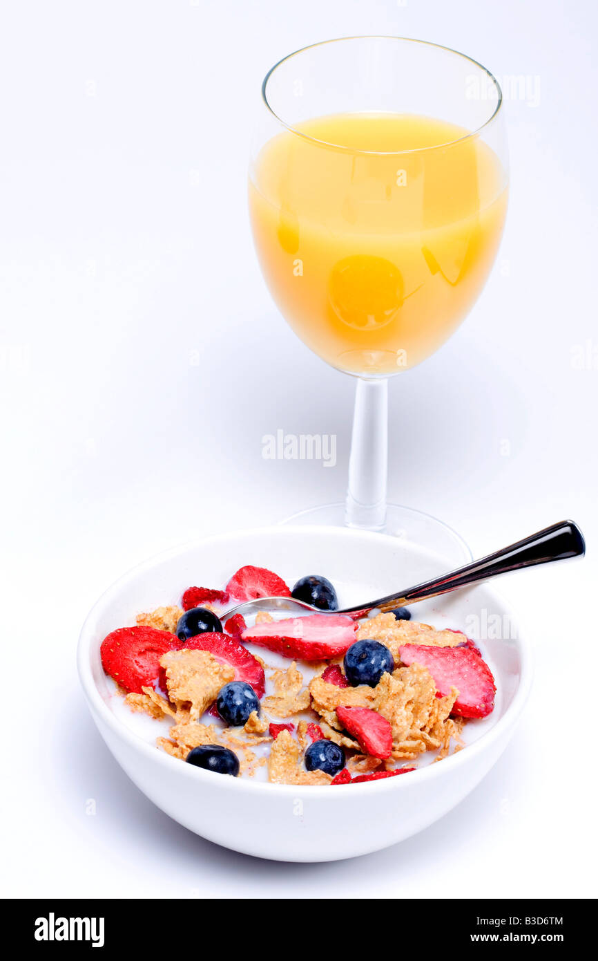 A bowl of cereal with a glass of orange juice Stock Photo Alamy