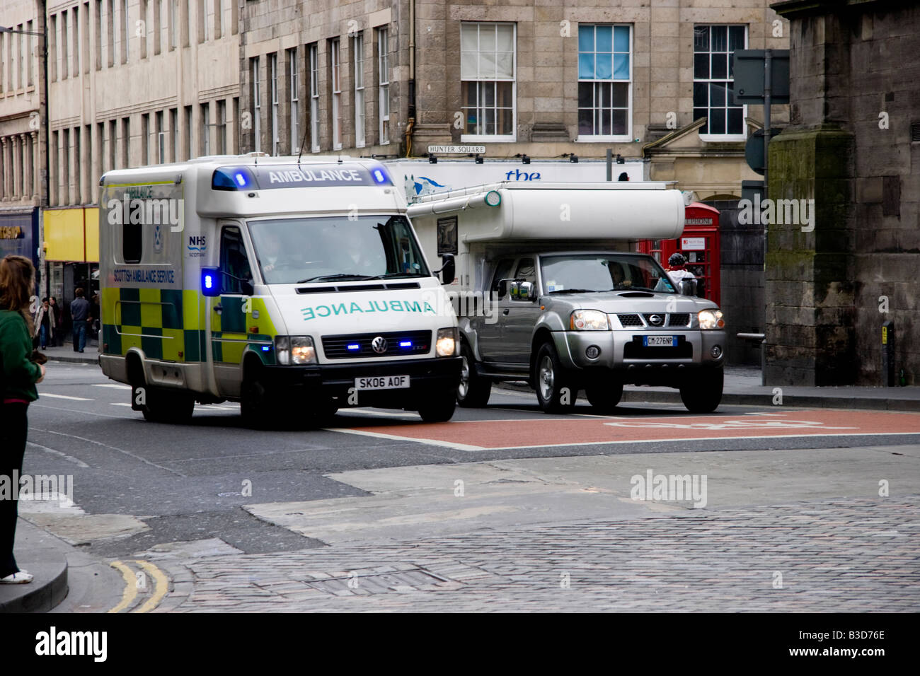 An ambulance on an emergency call, negotiating the junction of South