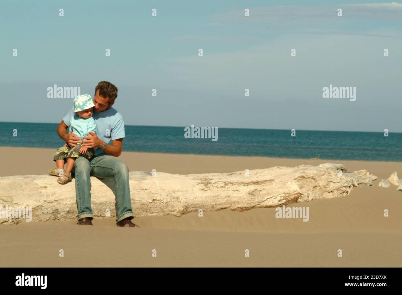 father and son together on beach in summer Stock Photo