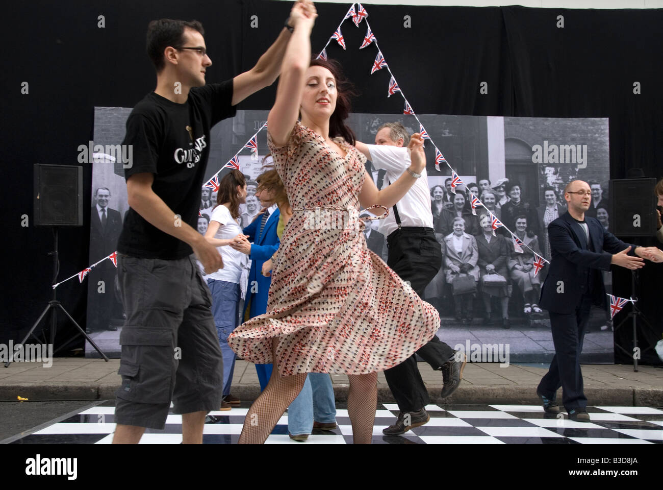 Street party to celebrate 1948 Olympic games on the day the Olympic flag was handed to London for 2012 Games .Couples dancing. Stock Photo