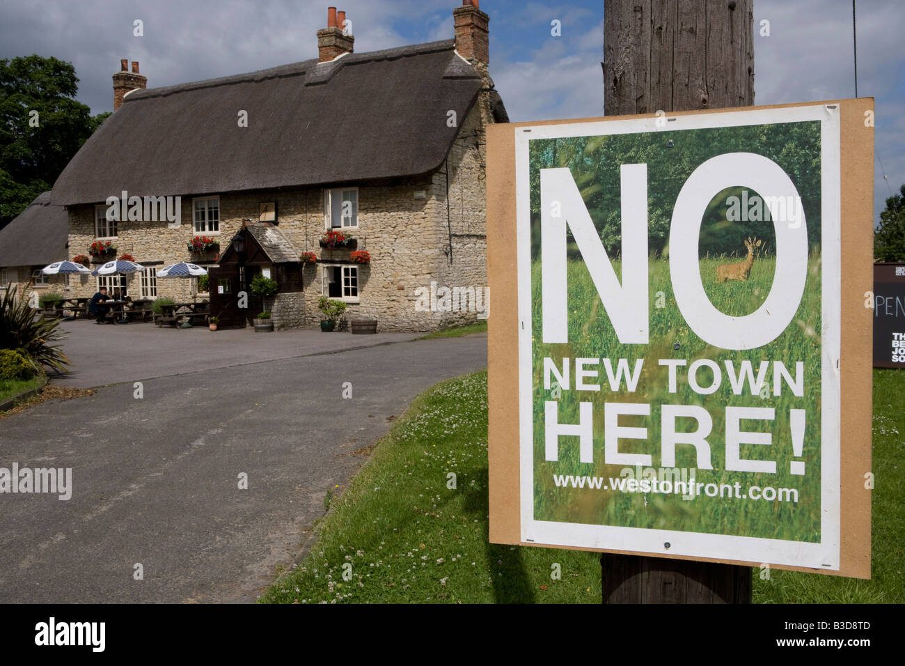 Residents display protest signs against the Weston On Otmoor eco town countering the Parkridge developments Eco town proposals Stock Photo