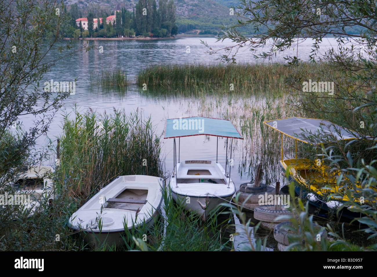 Visovac on Krka river in Croatia, moored boats in early morning Stock Photo