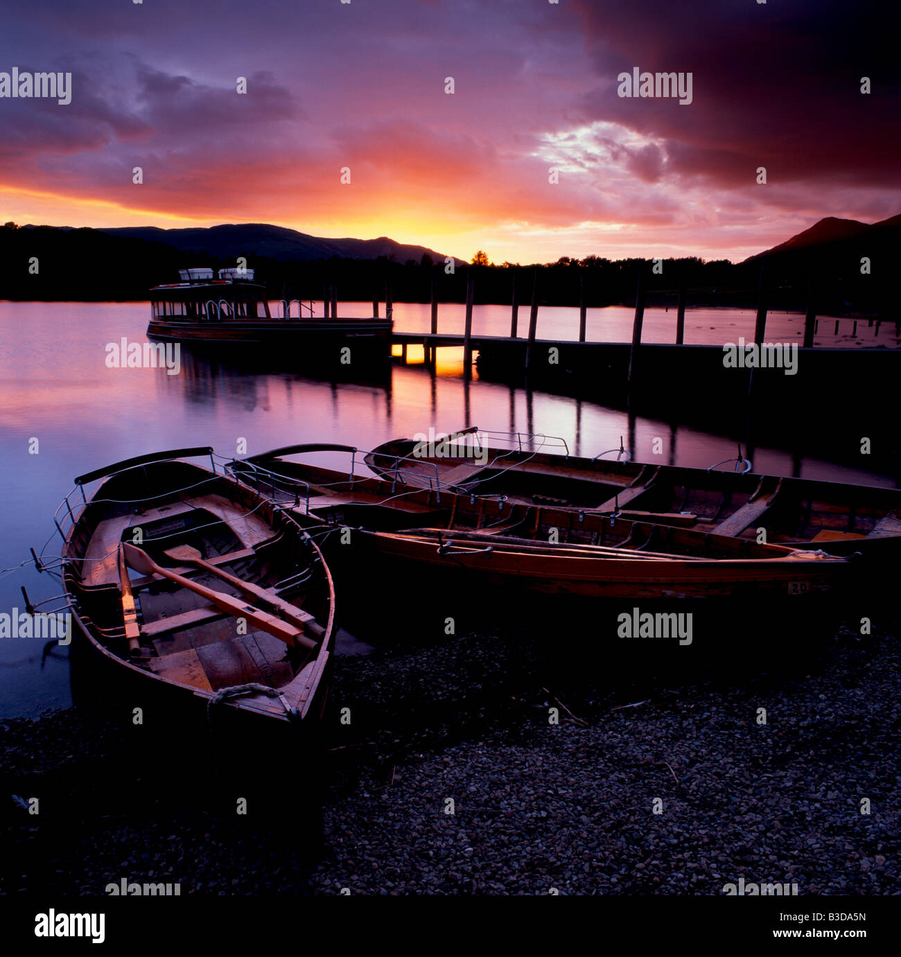 Rowing boats on Derwentwater in front of an amazing sunset at Keswick, Cumbria, England, UK Stock Photo