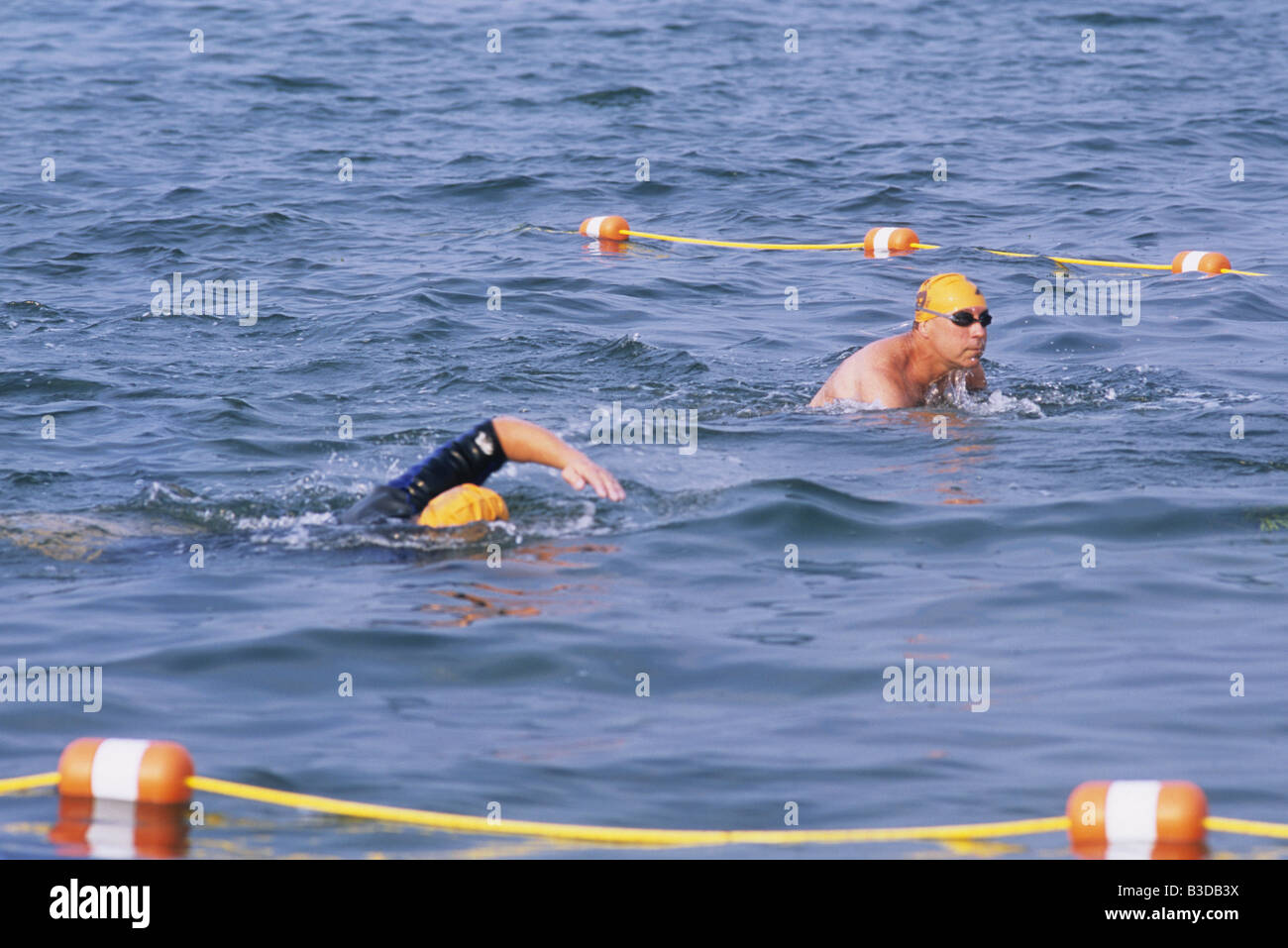 2 Two people one man swimming meet race in lane marker with swim cap